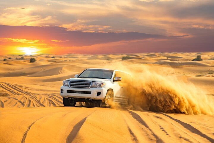 Experience the majestic UAE desert where a thrilling Jeep ride reveals stunning sunsets and sandy landscapes complemented by camel rides sandboarding and engaging cultural activities for an unforgettable adventure.
